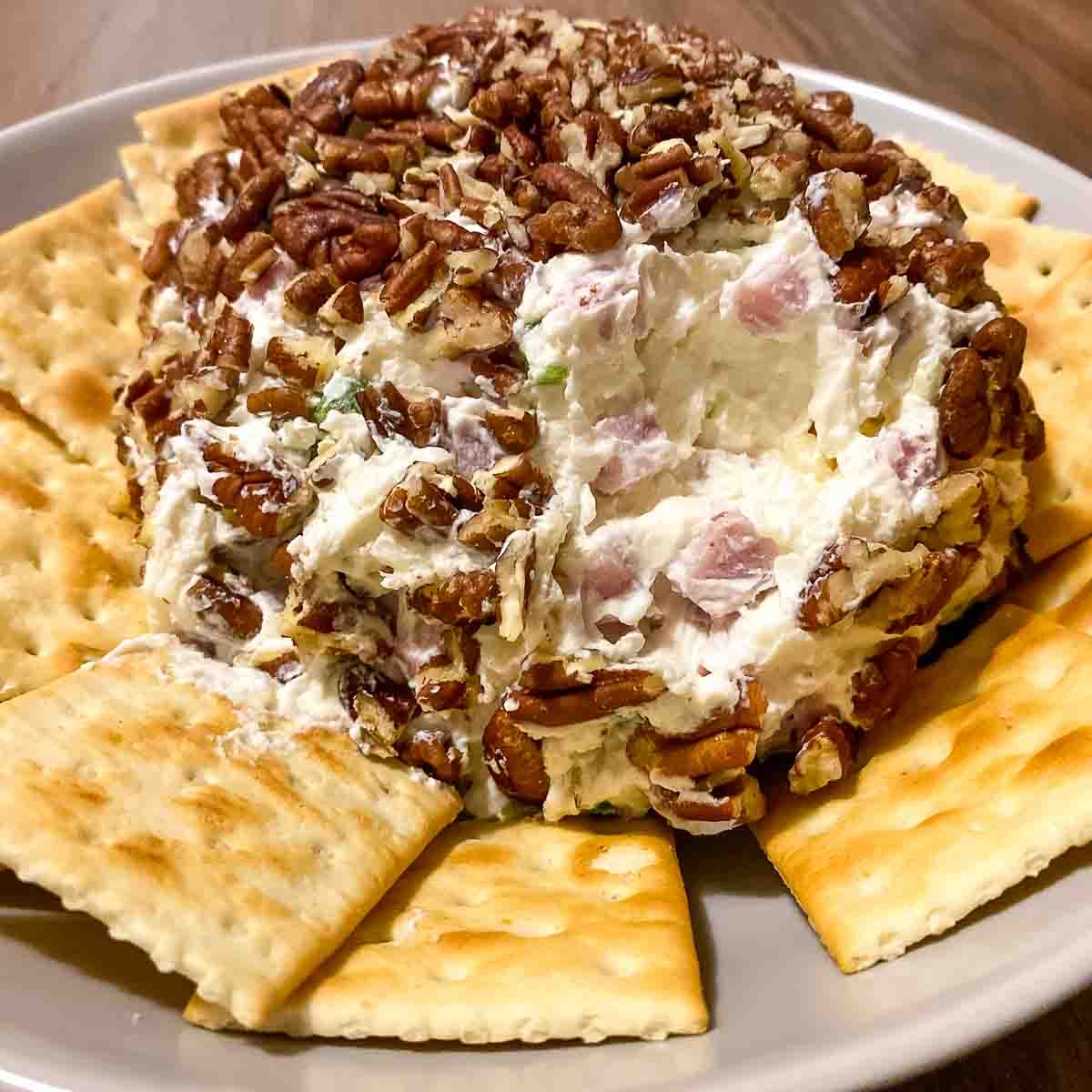 Pineapple Pecan Cream Cheese Ball served with crackers.