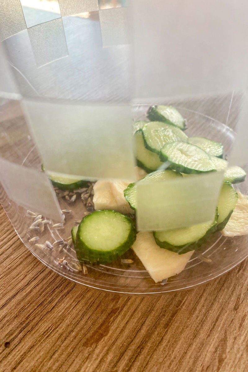 Cucumber Ginger Lavender Lemonade- slices of lemon, cucumbers and ginger in the pitcher- part of the recipe
