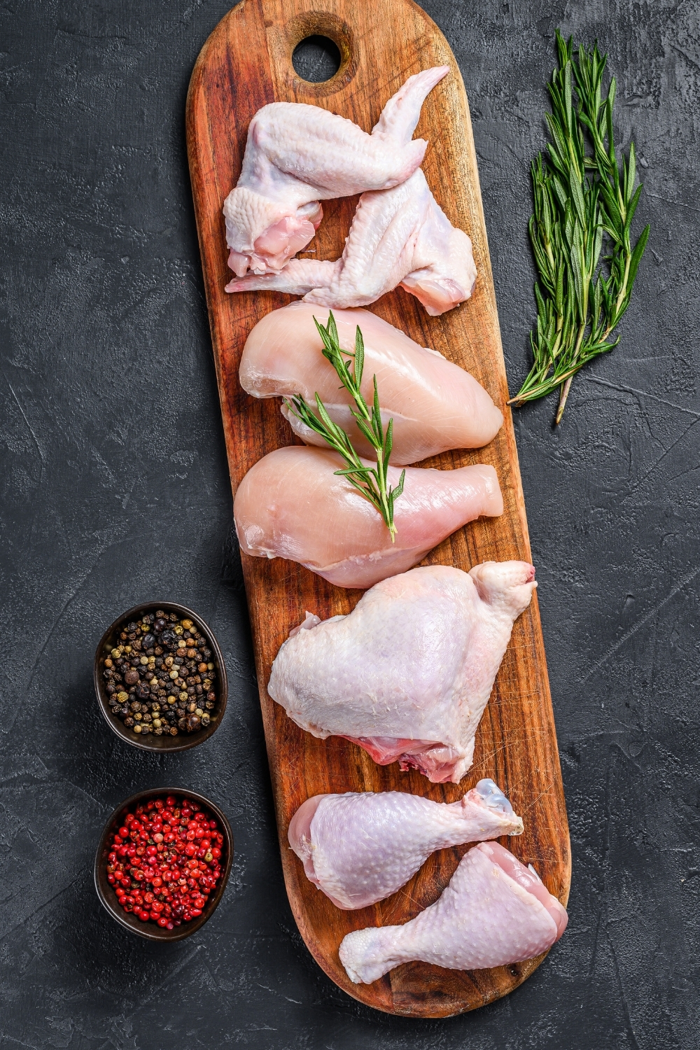 Chicken meat on a wooden board for Caldo de pollo 