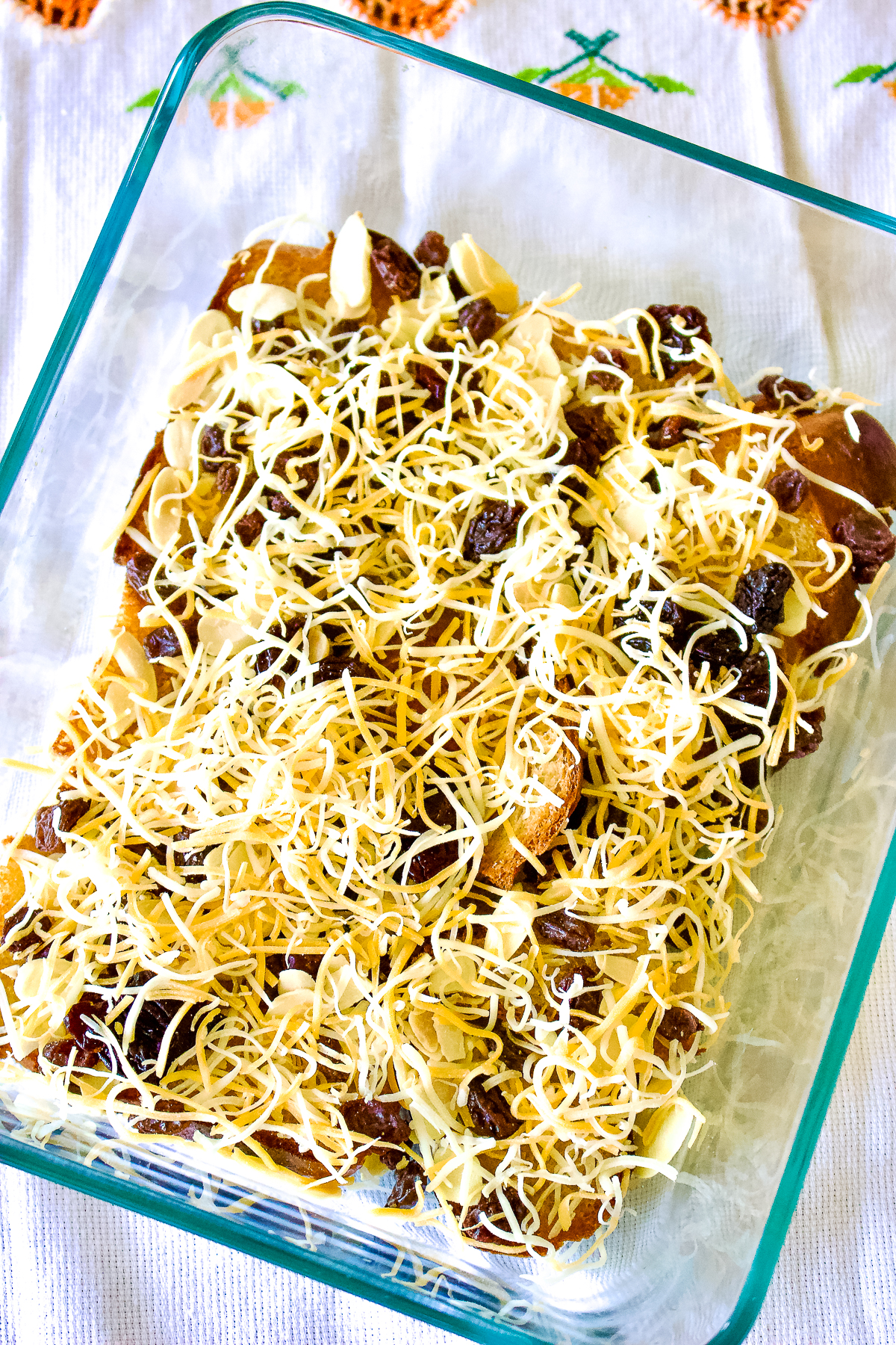 Authentic Mexican Capirotada- Bread Pudding is the Mexican version of the so popular bread pudding that you can find in many cuisines. This Capirotada is traditionally eaten during Lent, before Easter but you can also make it all year round. It is good for parties, holidays or Sunday meals in the family. Layers in a baking pan for Capirotada