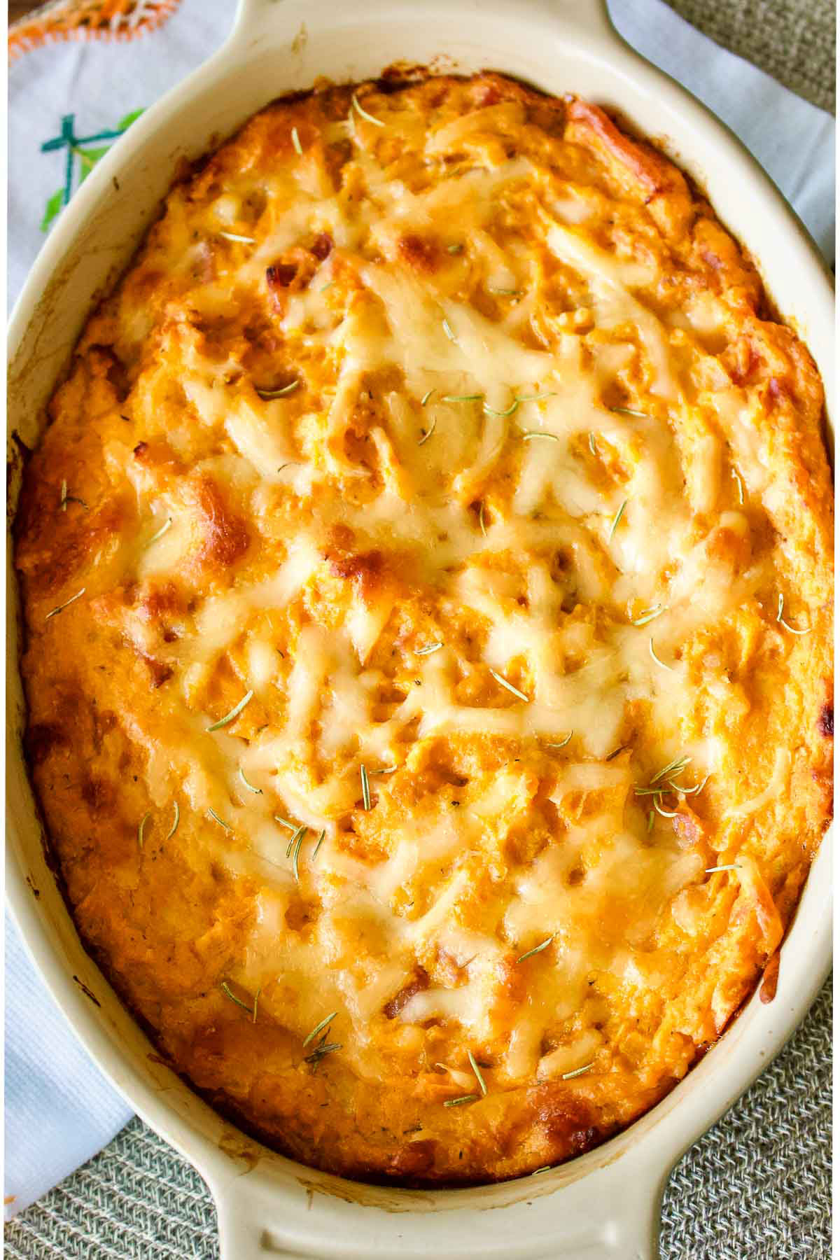 fresh out of the oven sweet potato casserole in a white casserole dish.