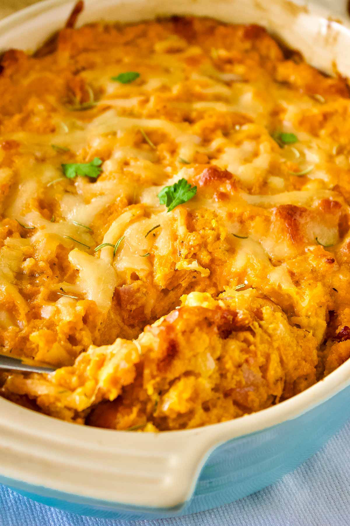 Savory sweet potato casserole with spoonready for serving.