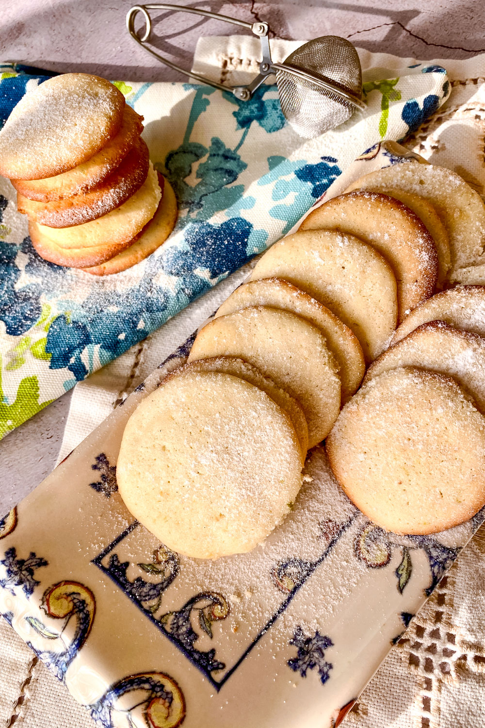 Lemon cream cheese cookies with powder sugar on blue and white towel0