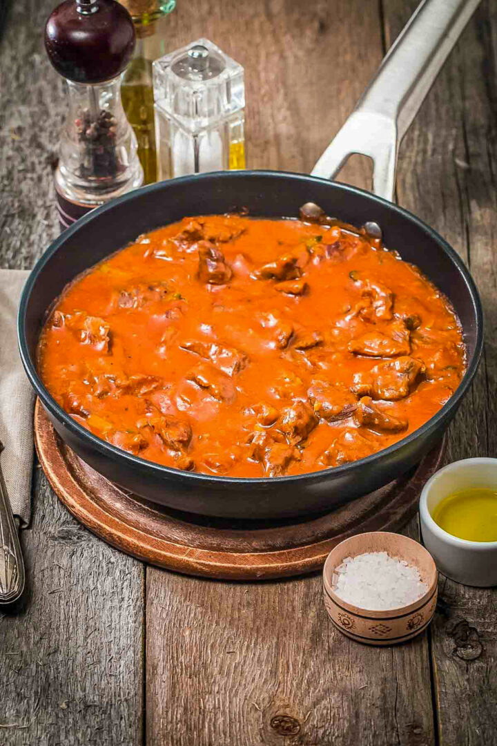 Delicious Spanish Meat in Tomato Sauce in a black bowl.