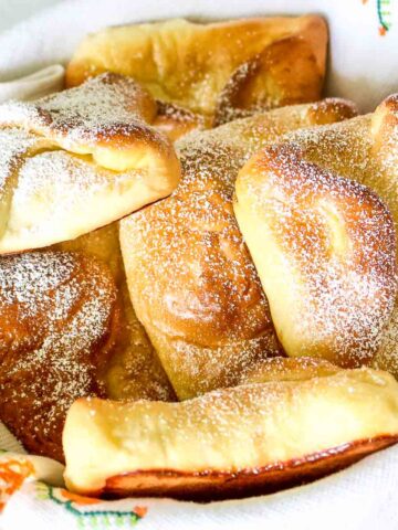 Sweet Cheese pastries (Poale in Brau) stacked in a basket.