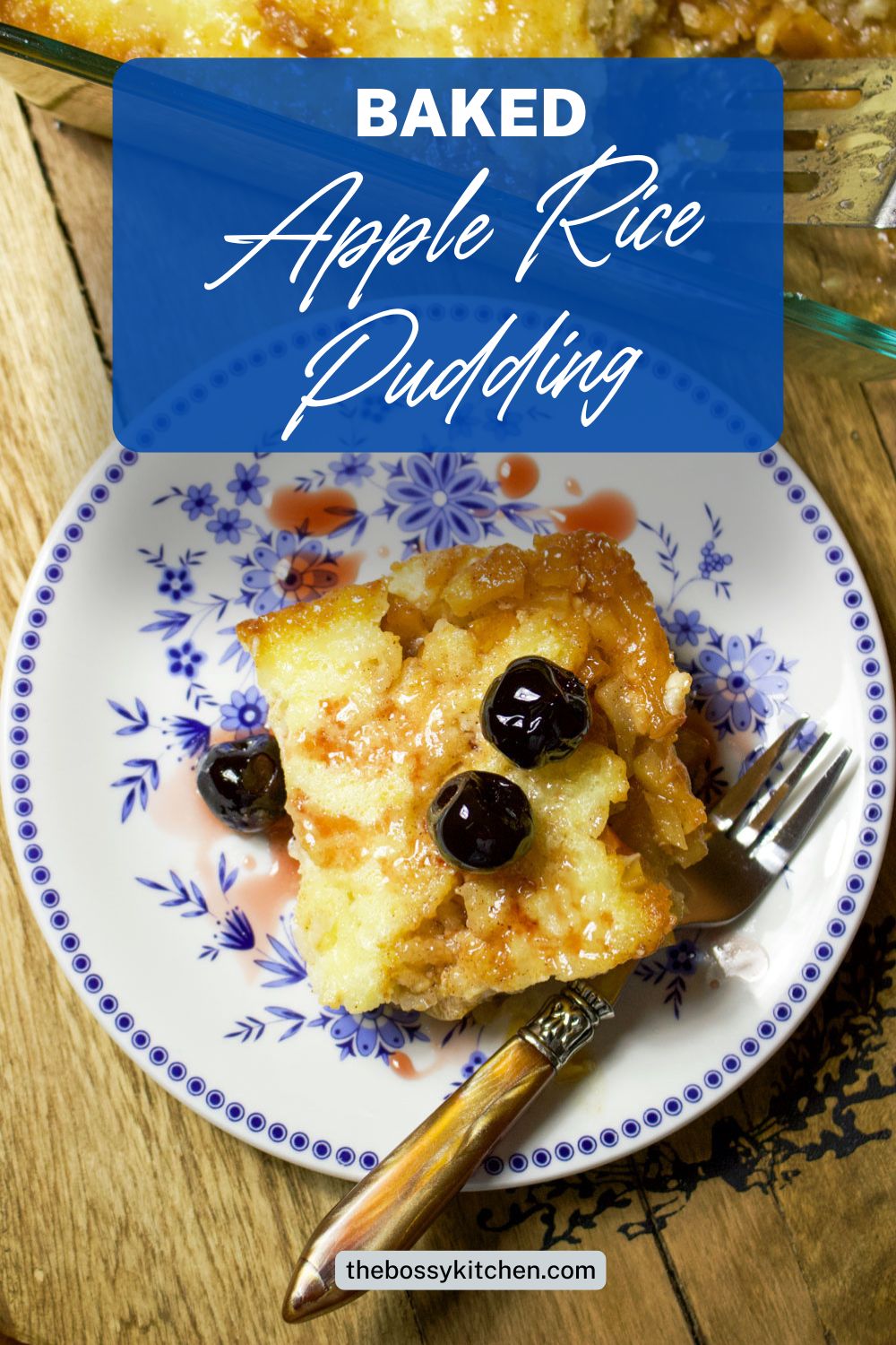 Slice of Baked Apple Rice Pudding on a white and blue plate with fork.