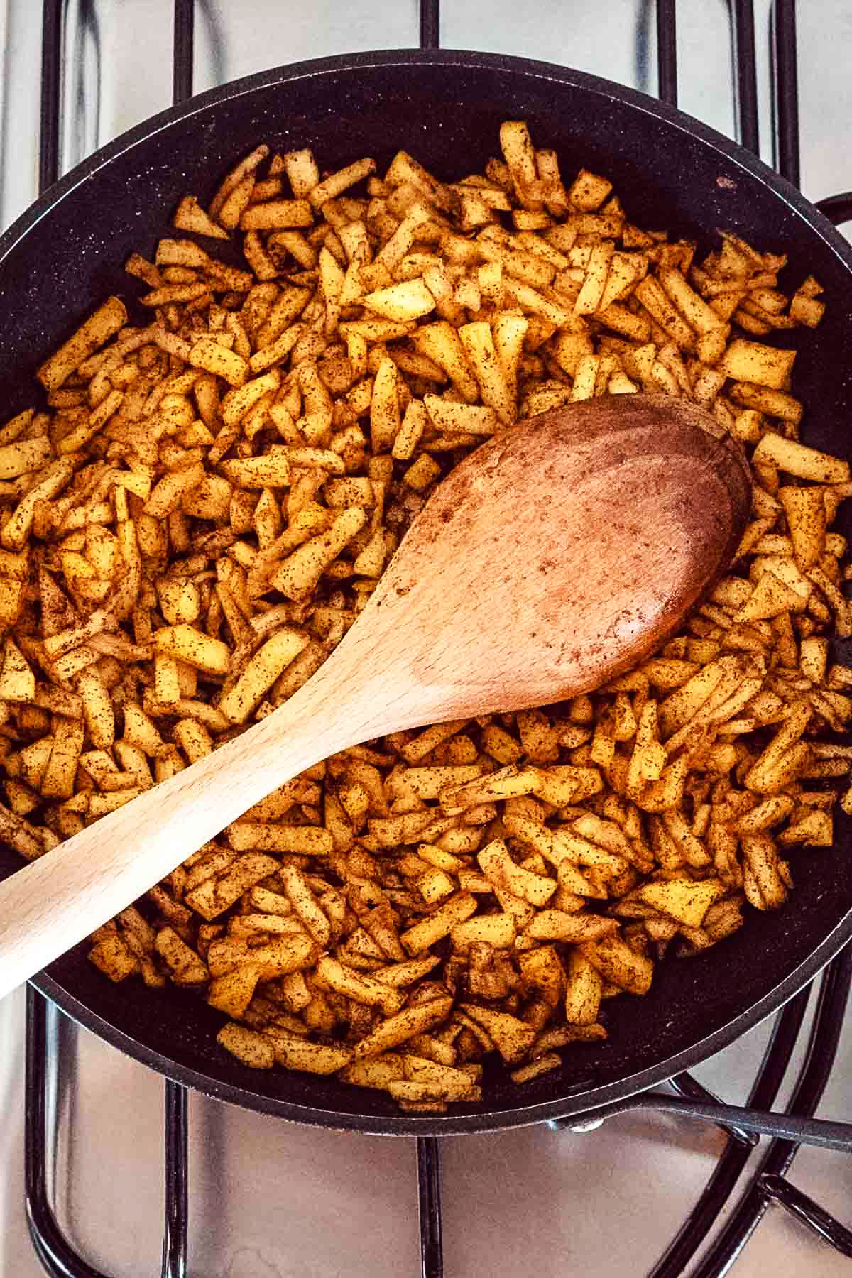 Cooked shredded apples in a skillet.