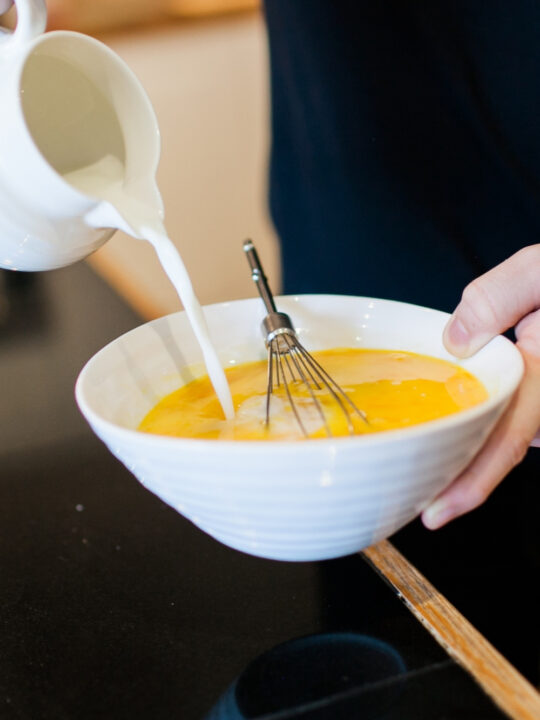 Making custard for blueberry bread pudding