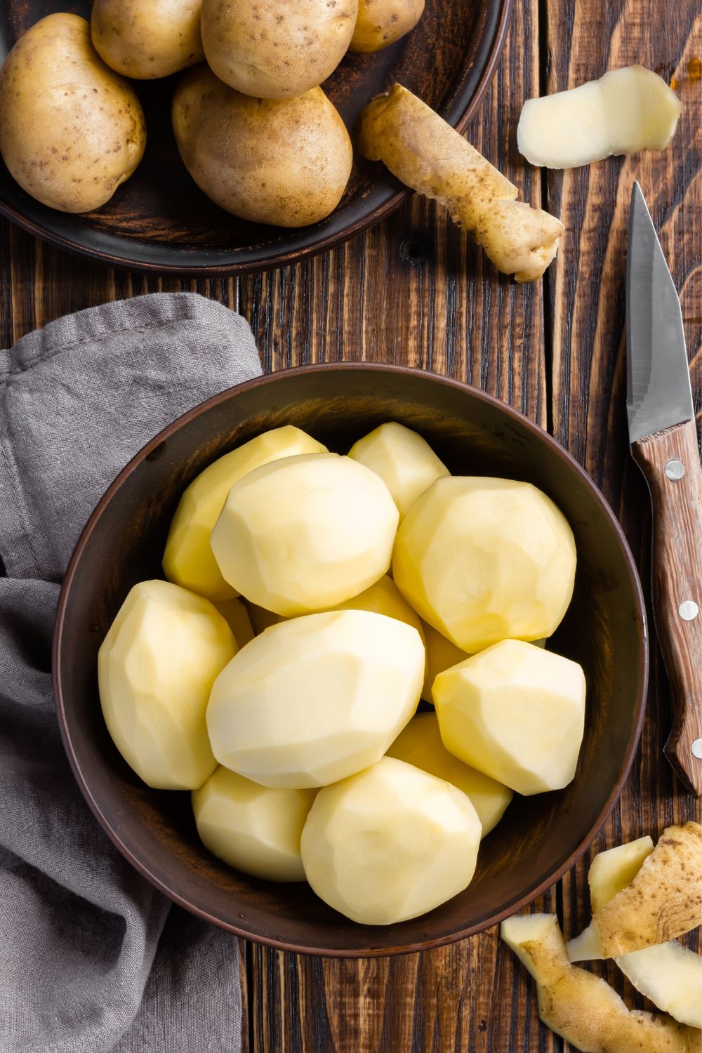 Peeled potatoes in a bowl for homemade French fries