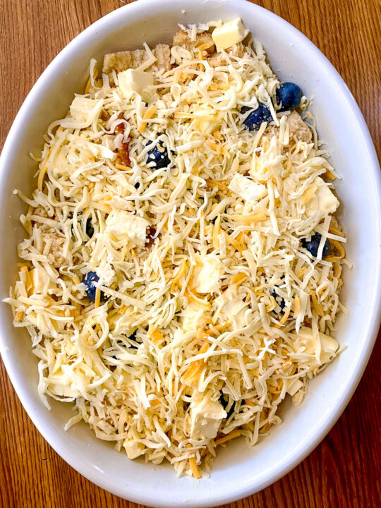Unbaked assembled Blueberry Bread Pudding With Cheddar