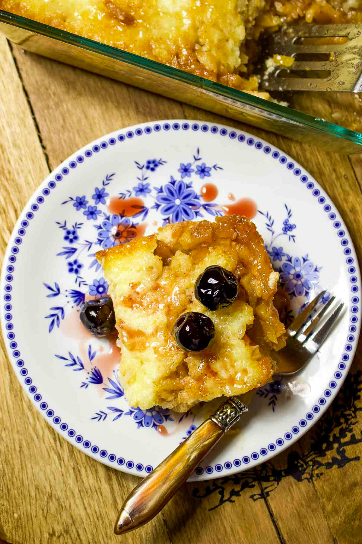 Slice Of Baked Apple Rice Pudding on a white and blue plate.