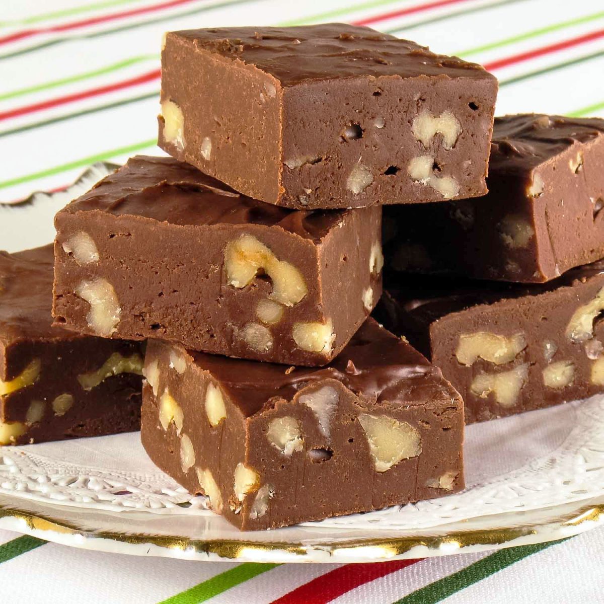 Coffee Fudge With Pecans stacked on a white plate.