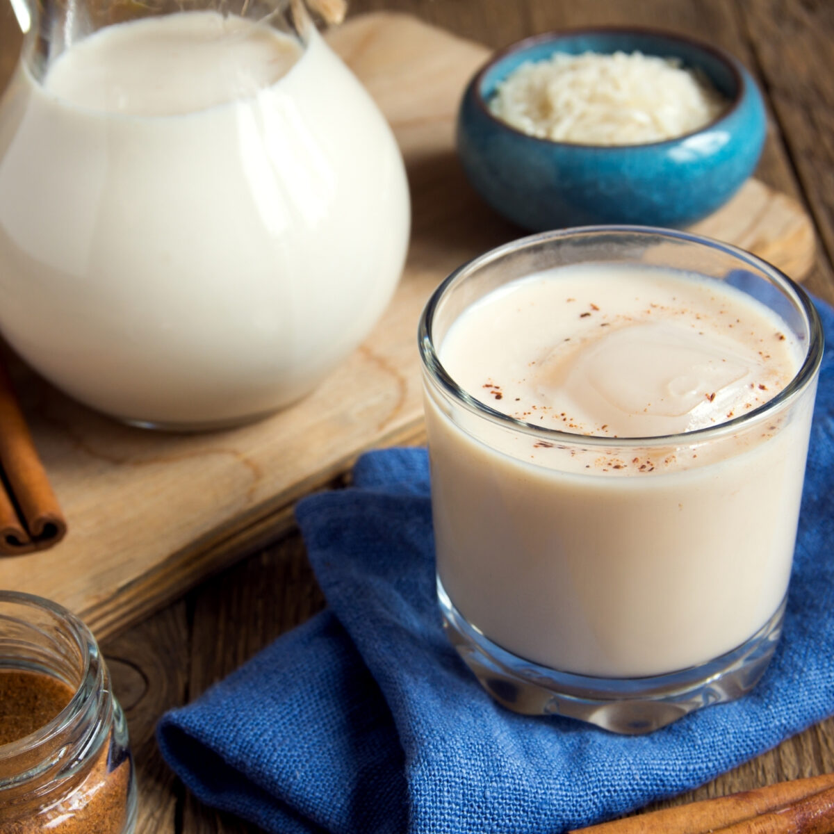 Mexican Horchata on glass with pitcher in the back and rice
