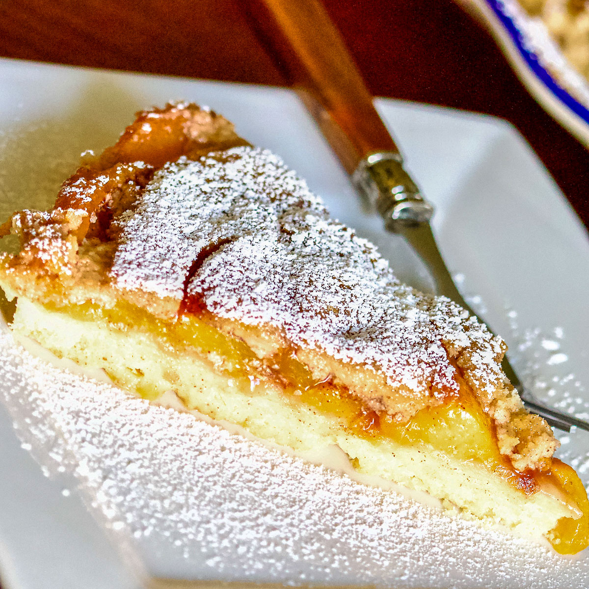 Peach Kuchen slice on a white square plate square image0