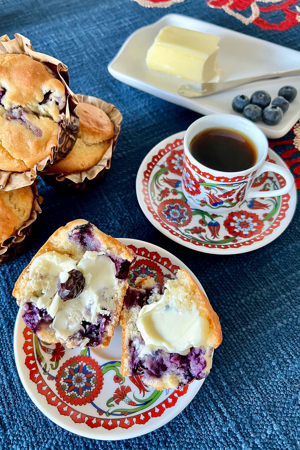 Blueberry Muffins with butter in the background0