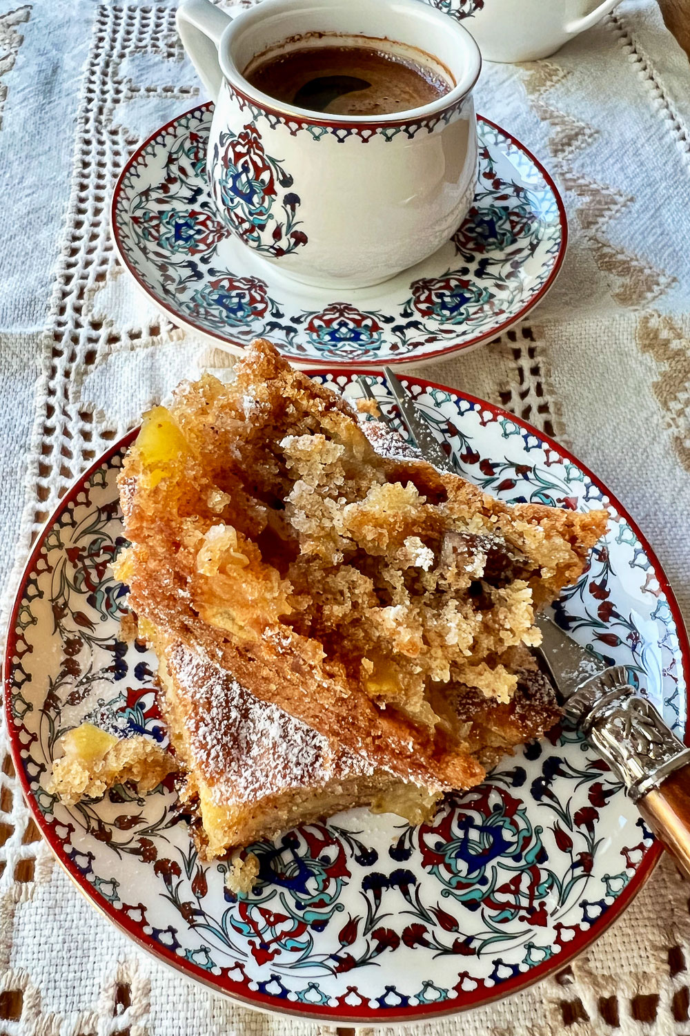 Easy Apple Bars piece on plate with fork and coffee in the background