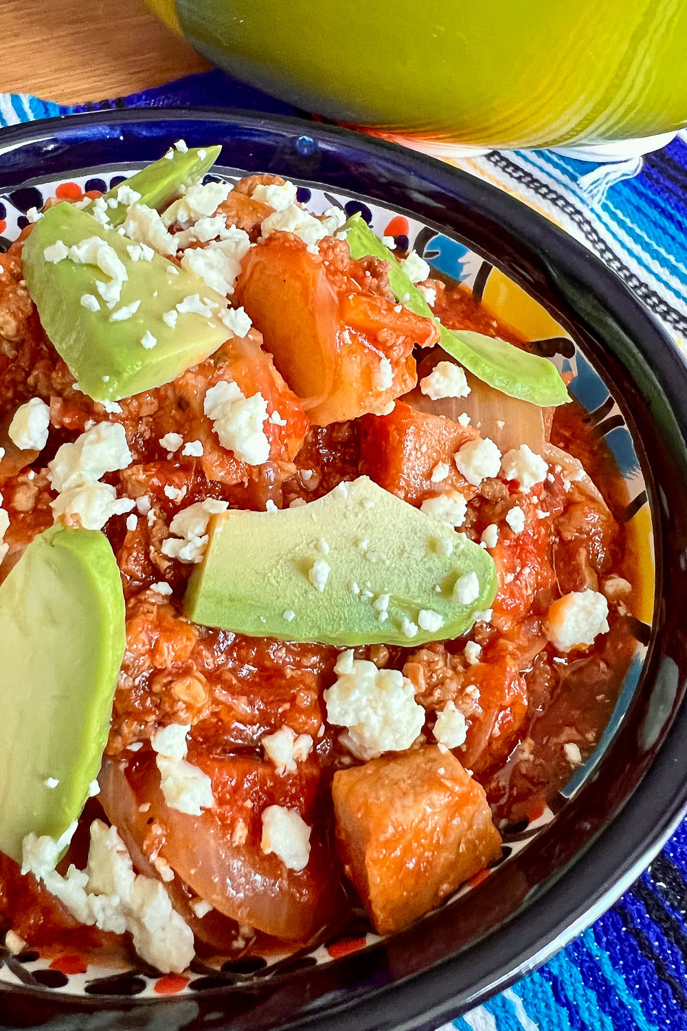 Mexican Pork Tinga-Tinga Poblana in a bowl with avocado and cheese