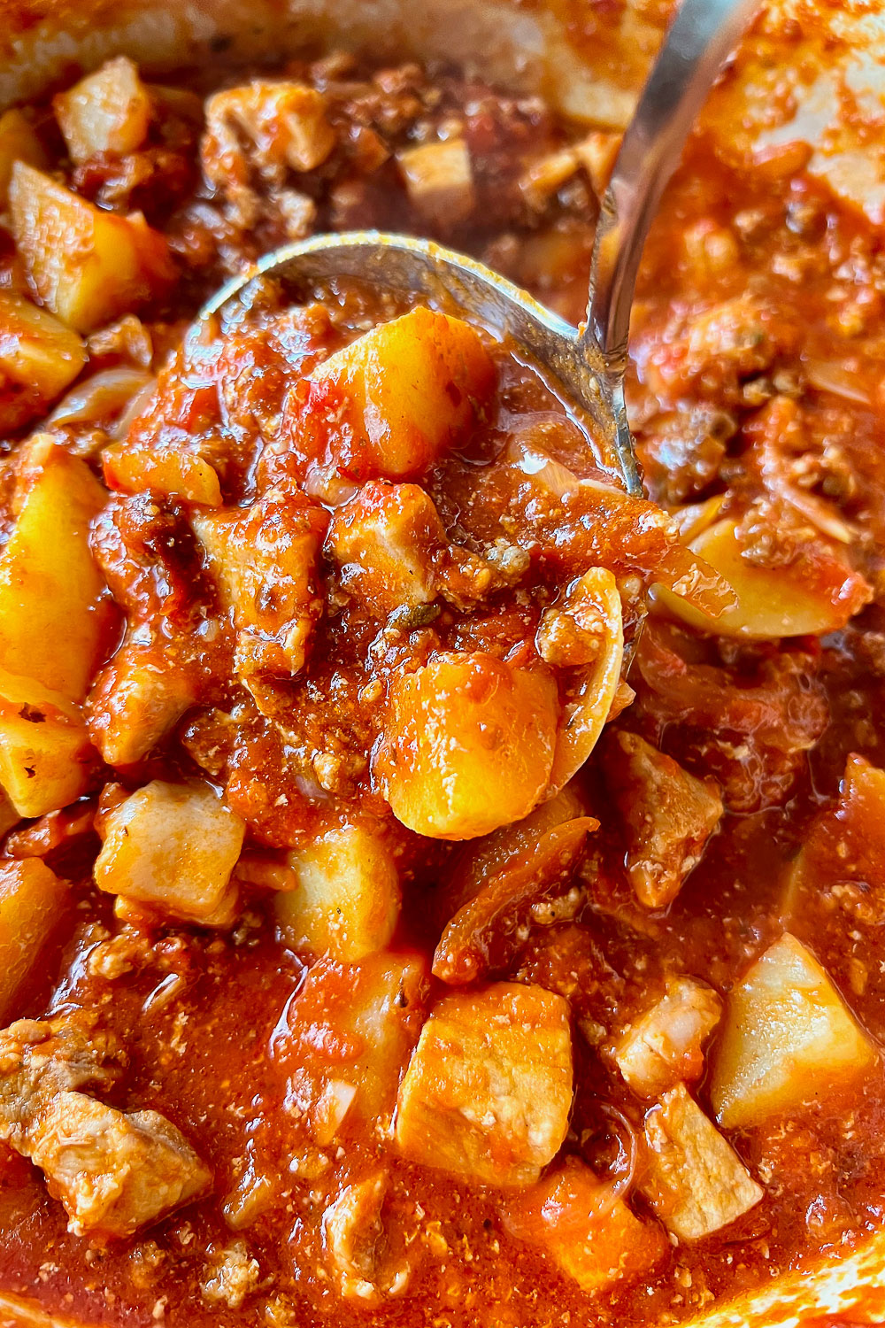 Mexican Pork Tinga(Tinga Poblana) in the pan with ladle.