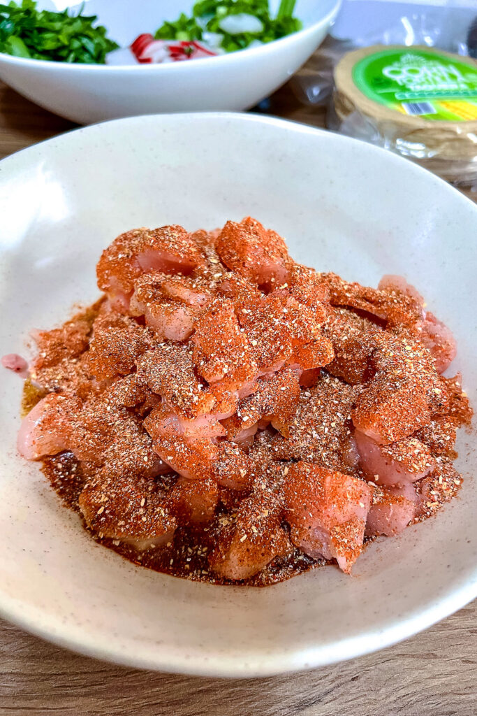 Chicken meat with oil and spices on a plate