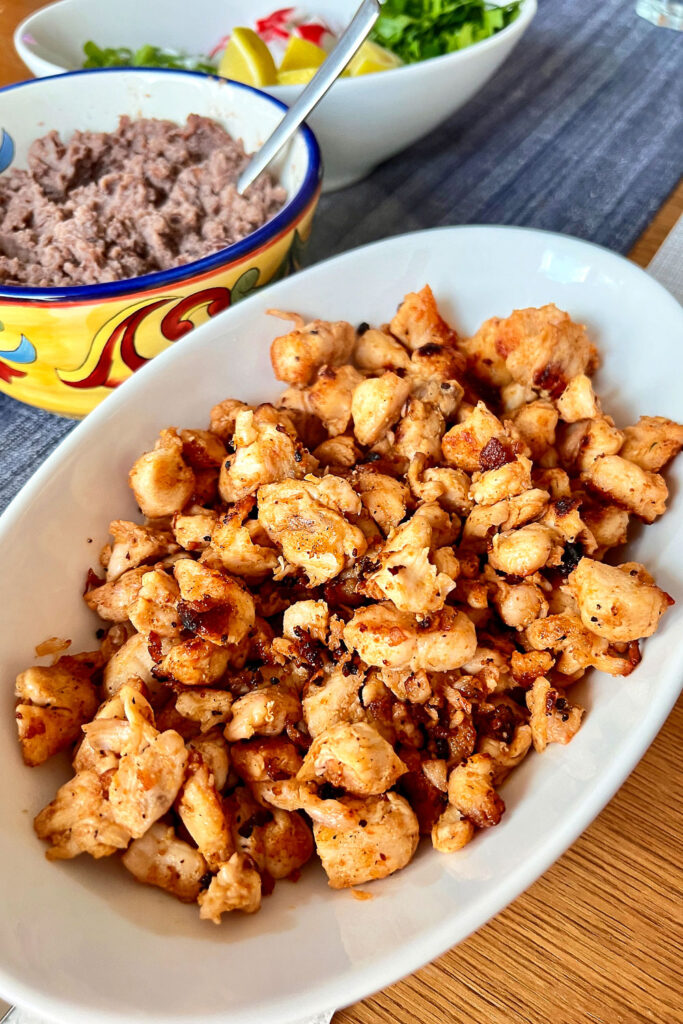 Cooked chicken in a white bowl