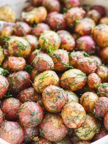 Baby potatoes With Dill and Butter in a serving dish.