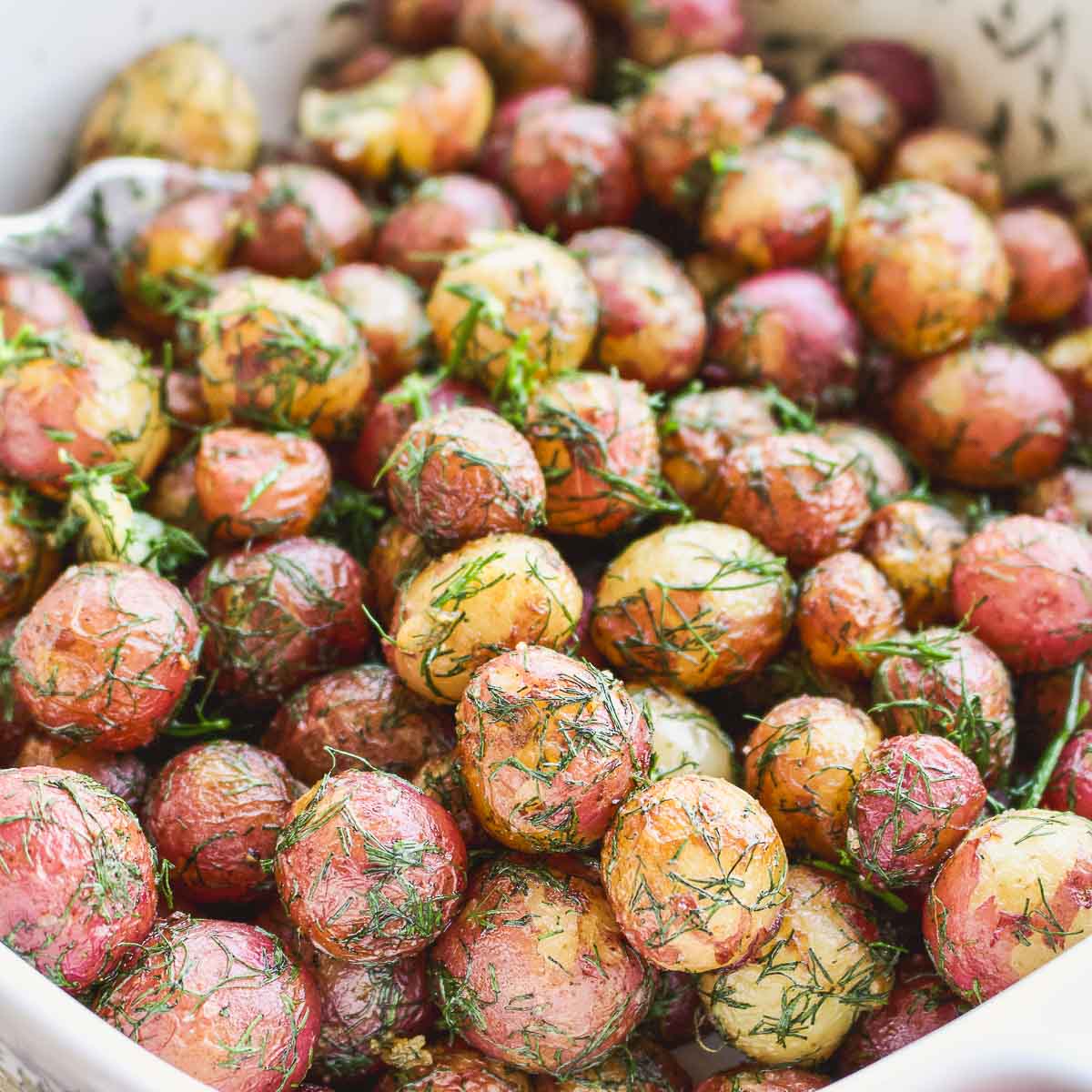 Baby potatoes With Dill and Butter in a serving dish.