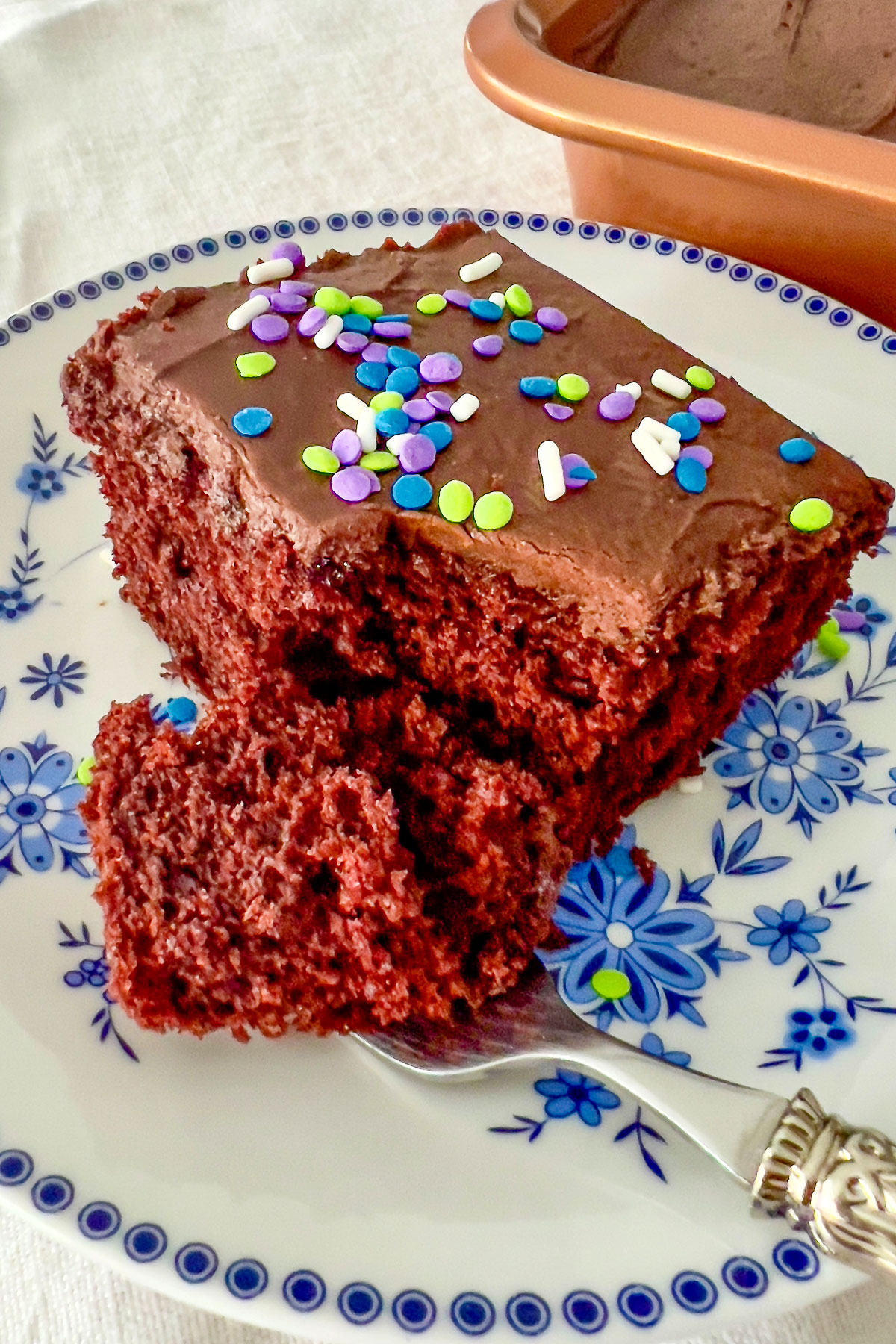 Wacky Cake on a white and blue plate with fork
