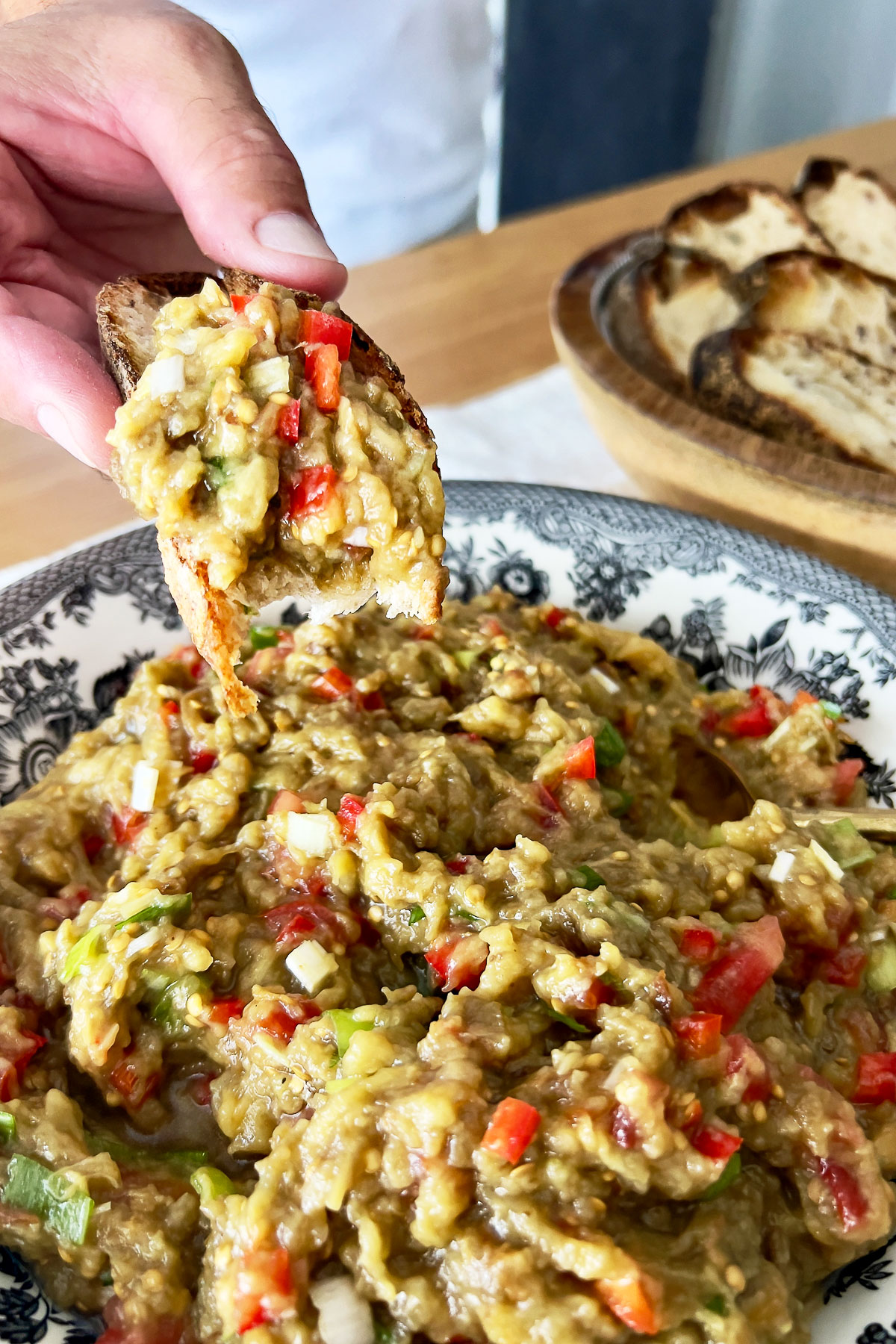 Mediterranean Roasted Eggplant Salad close up with a slice of bread.