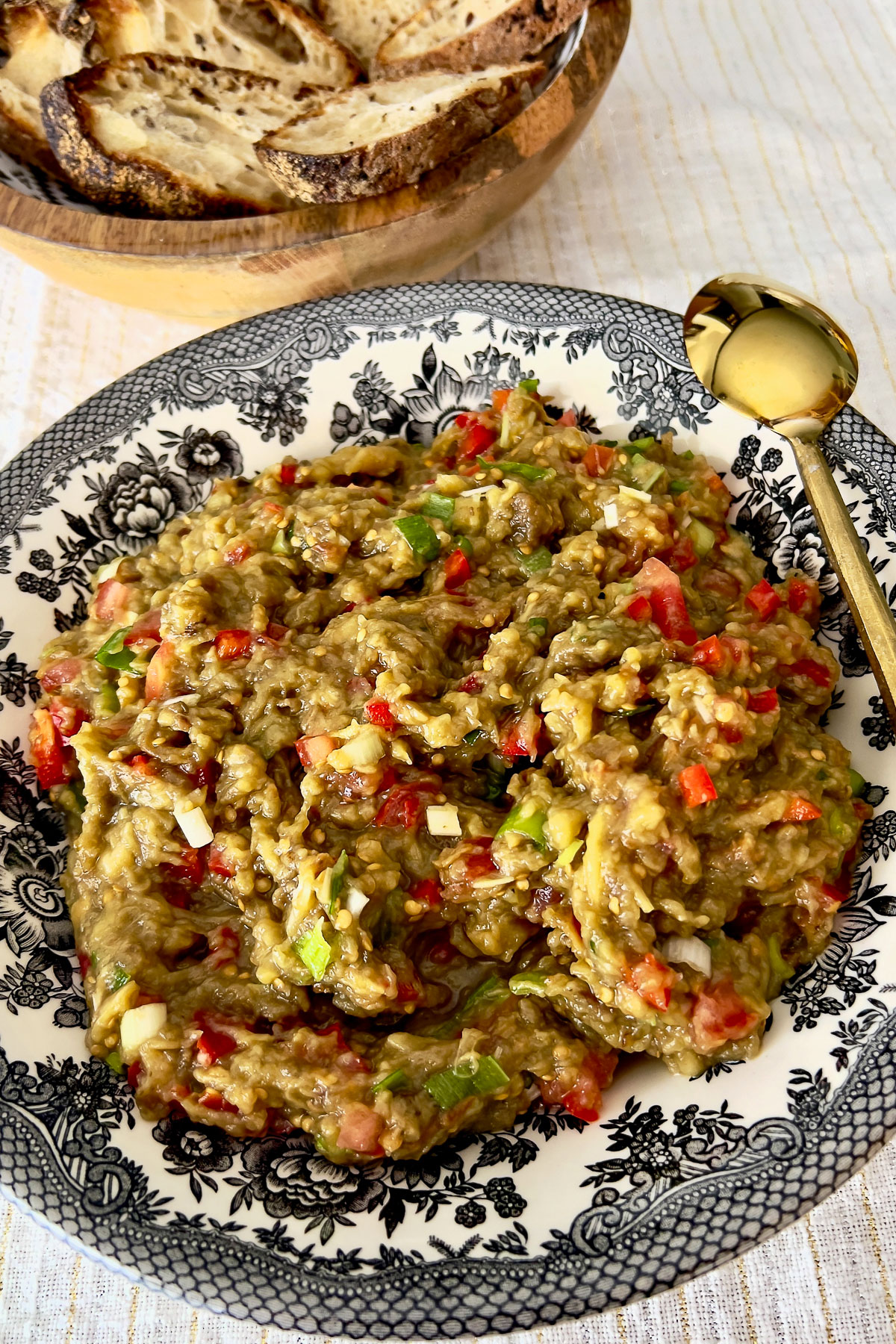 Mediterranean Roasted Eggplant Salad with golden serving spoon.