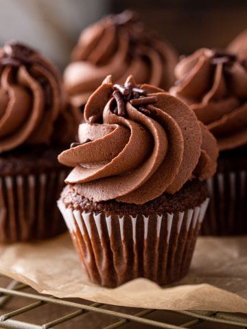Gluten Free Chocolate Cupcakes With Chocolate Ganache sitting on a cooling rack.