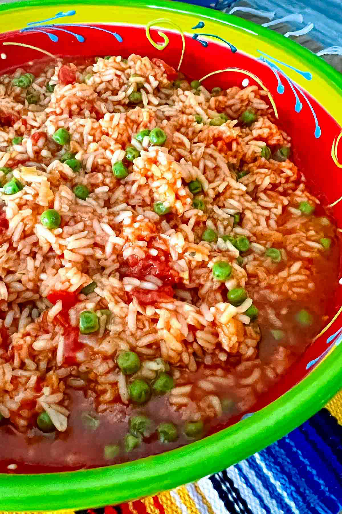 Mexican red rice (Arroz A La Mexicana) in a colorful large bowl.