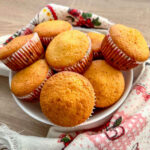 Corn muffins stacked on a plate.