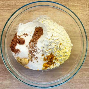 Dry ingredients in a glass bowl for Cranberry Orange Muffins.