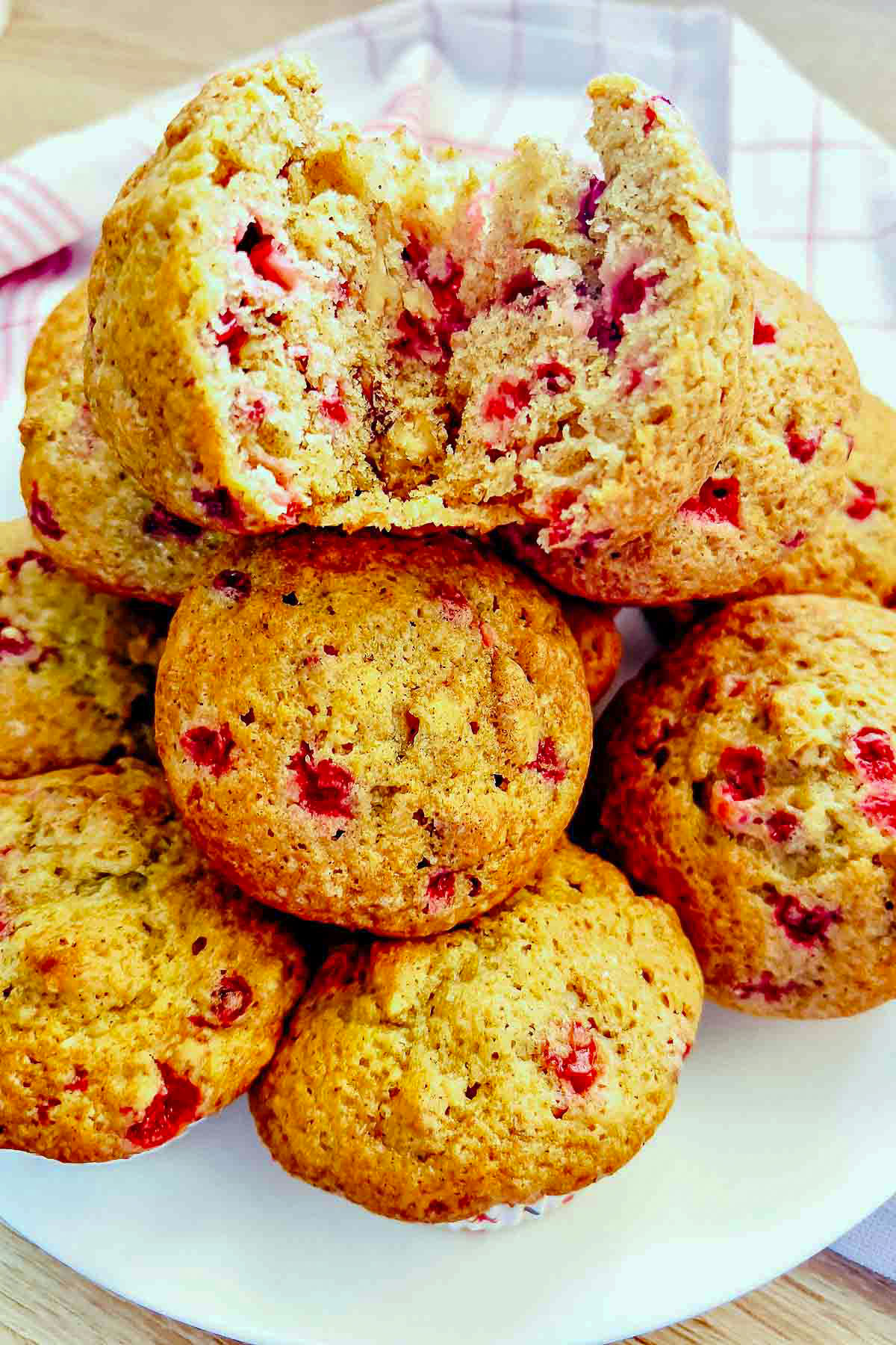 Stacked cranberry orange muffins.