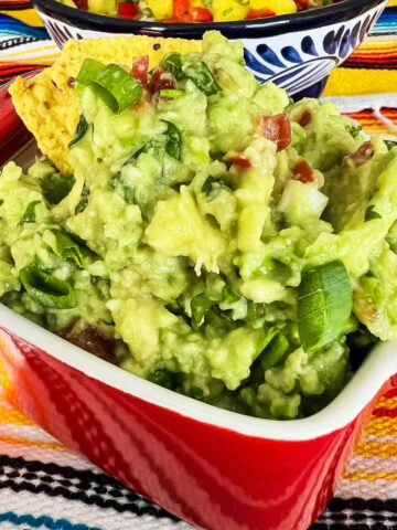 Guacamole in a red bowl.