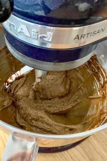 Mixing the wet ingredients with the butter and sugar.