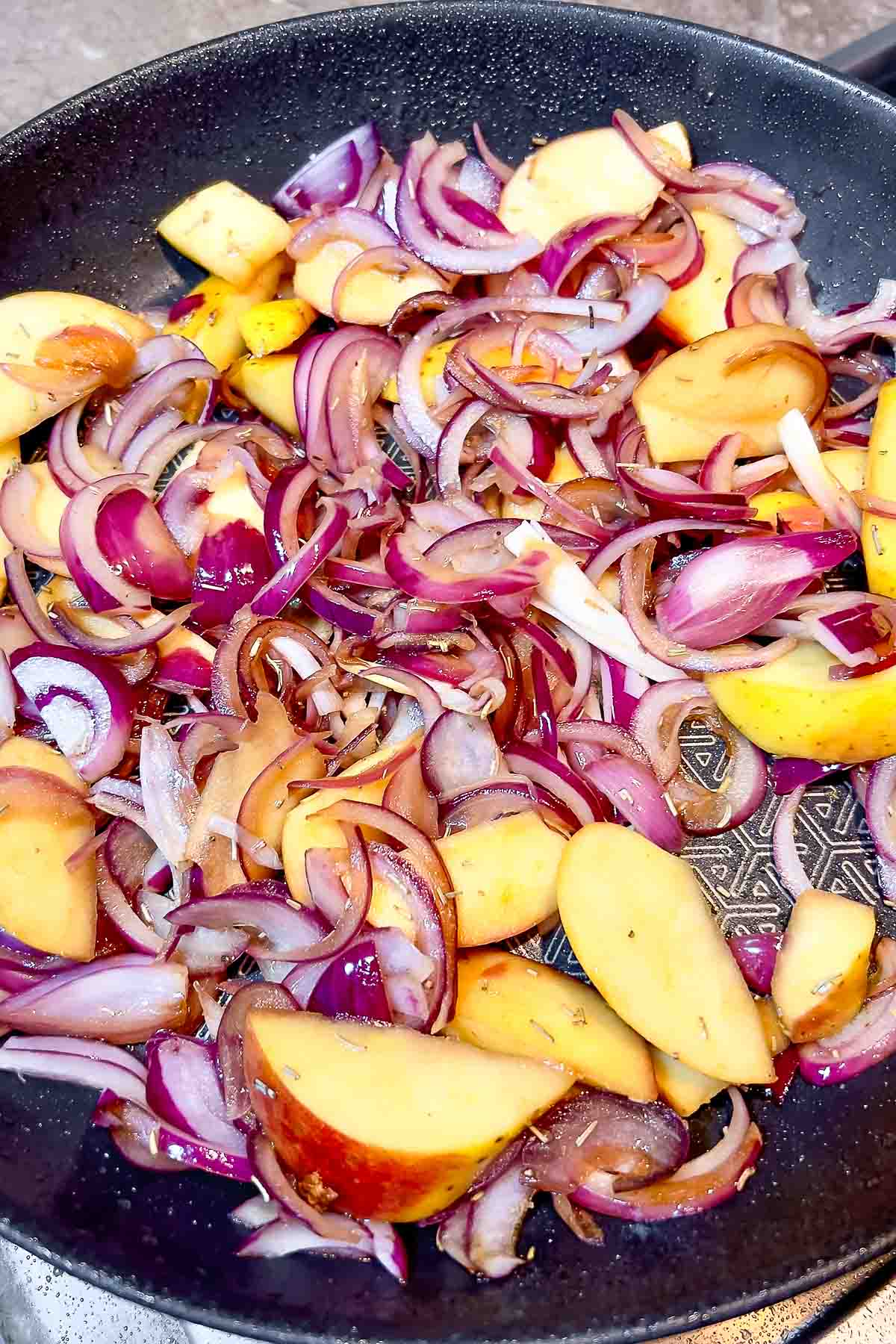 Cooking apples and onions with spices.