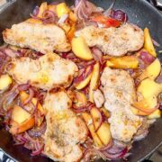 Pork Loin Slices with Onions and Apples in a skillet.