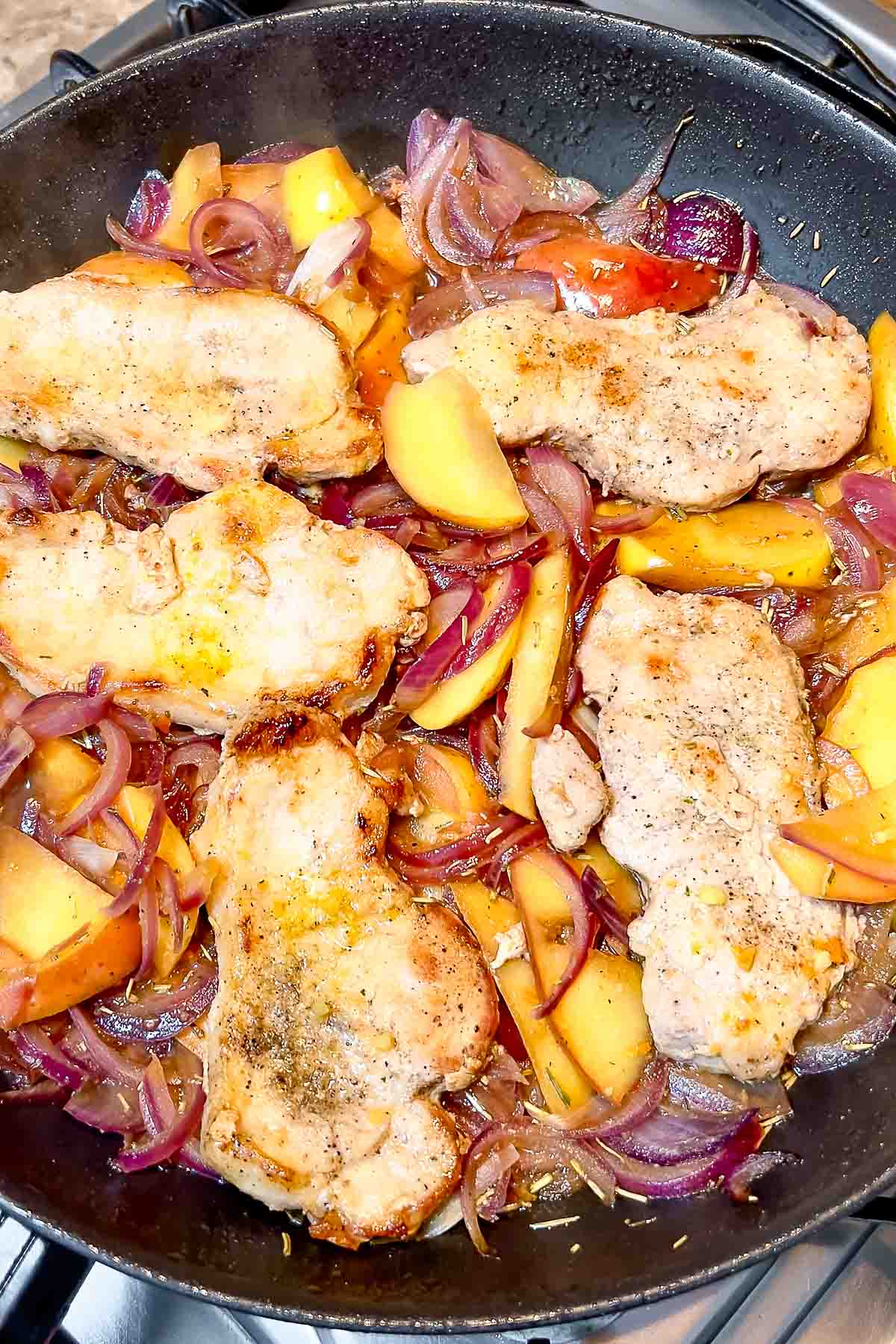 Pork With Apples and Onions in a skillet.