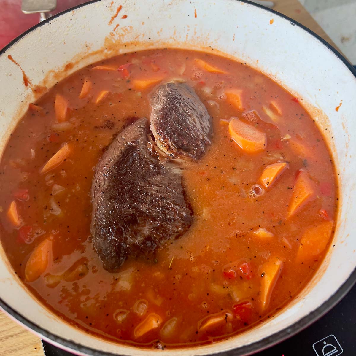 Adding meat to the sauce.