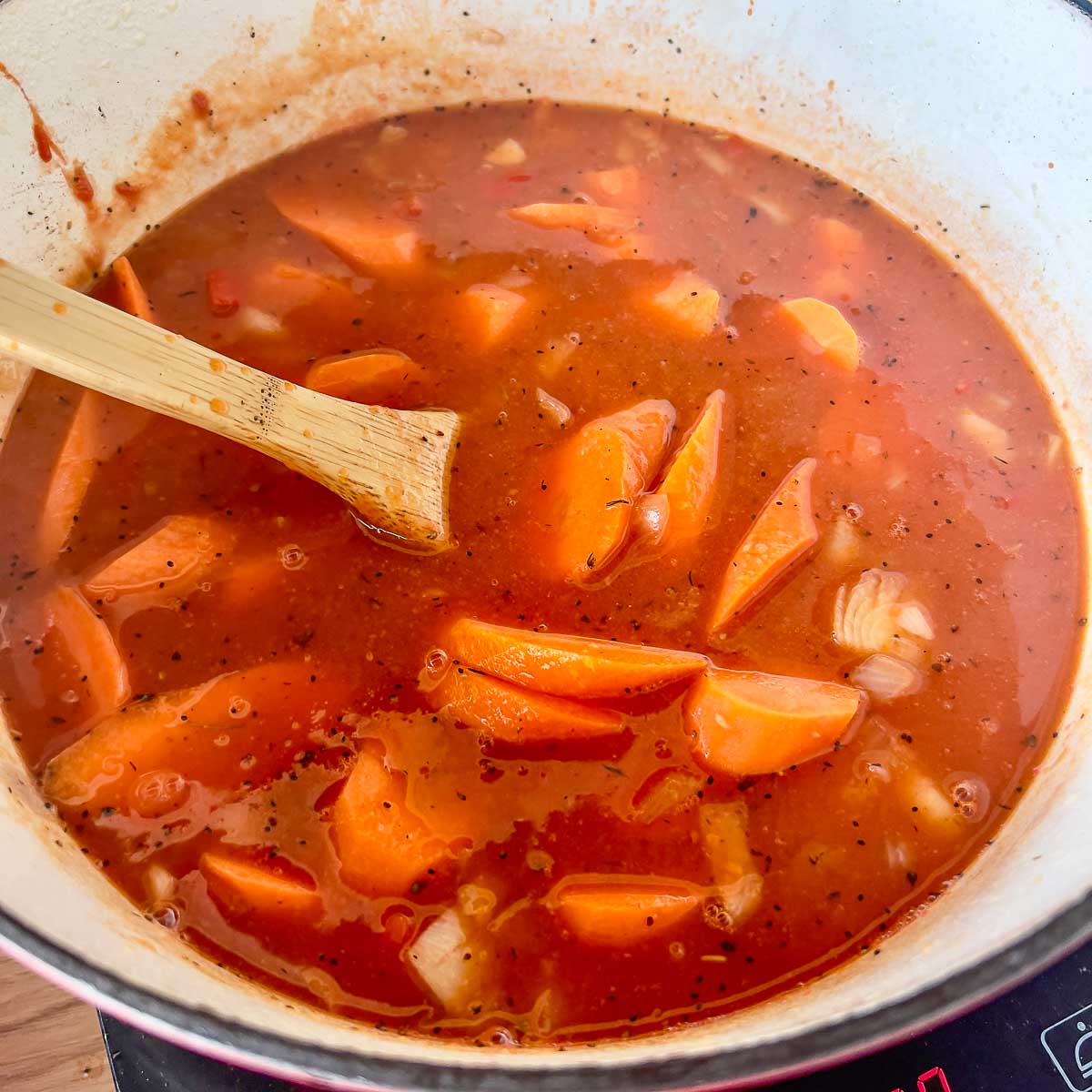 Adding water to the vegetables.