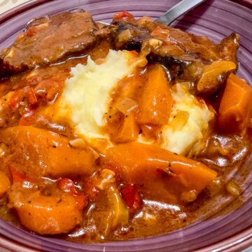 Dutch Oven Beef Pot Roast served with mashed potatoes .