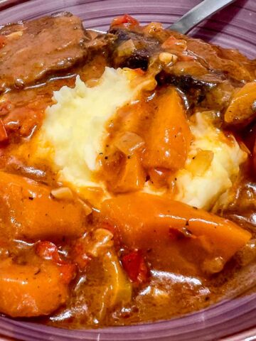 Dutch Oven Beef Pot Roast served with mashed potatoes .