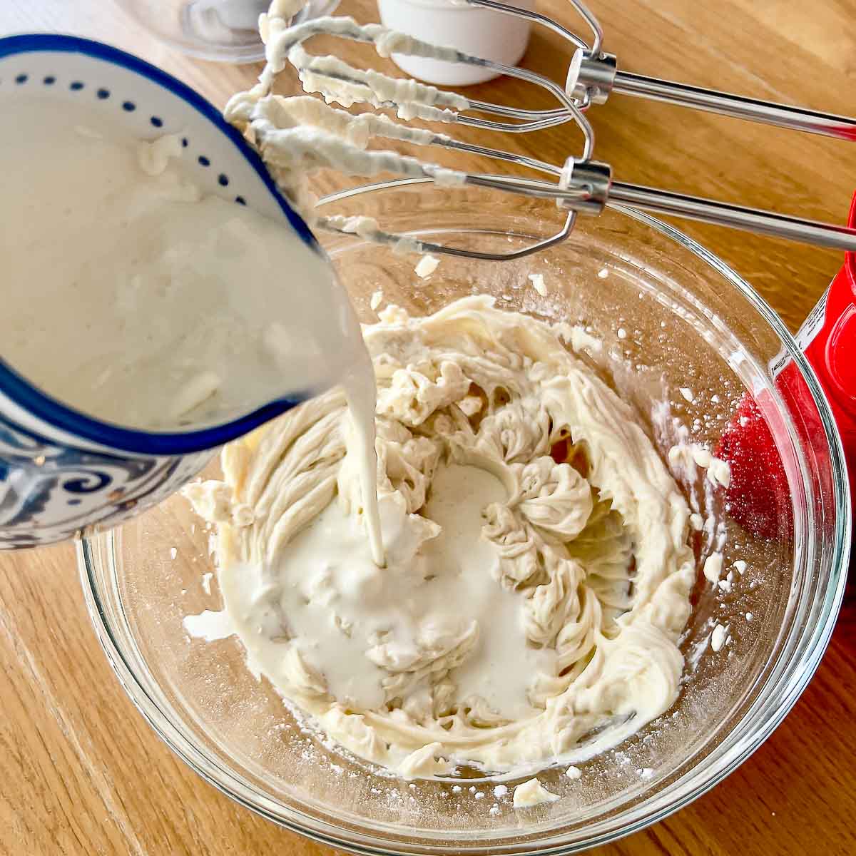 Mixing cream cheese with heavy cream.