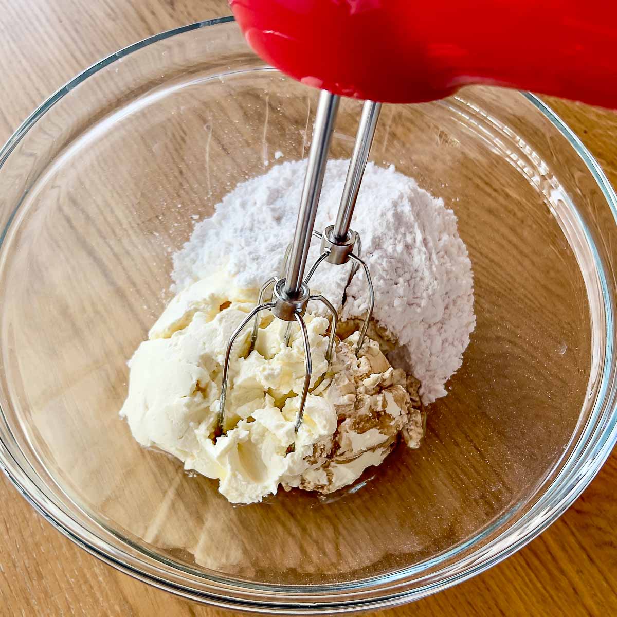 Mixing cream cheese with vanilla and sugar.