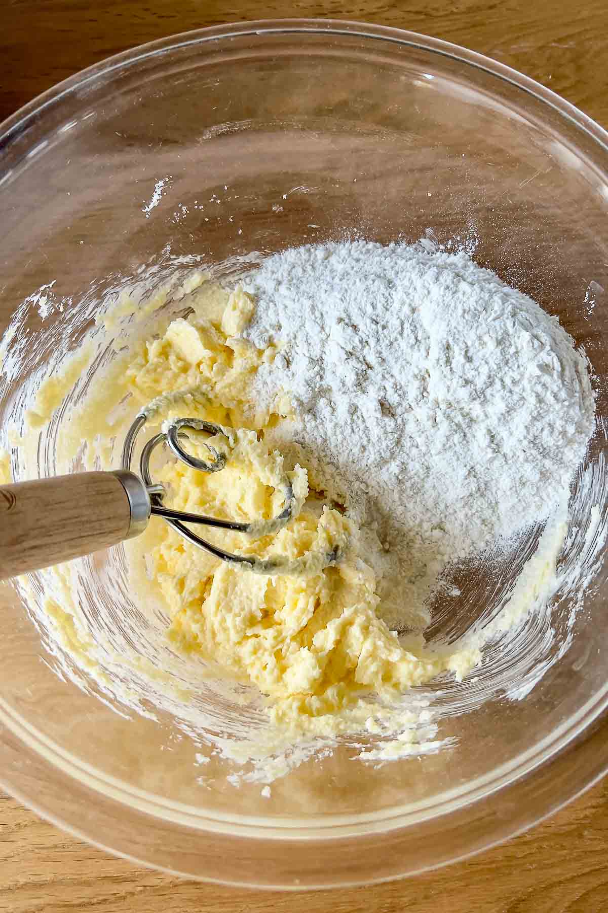 Mixing the butter with sugar and flour for the crust.