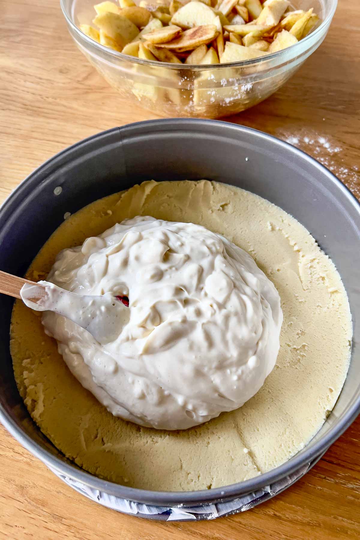 Placing the cream cheese filling on the crust.
